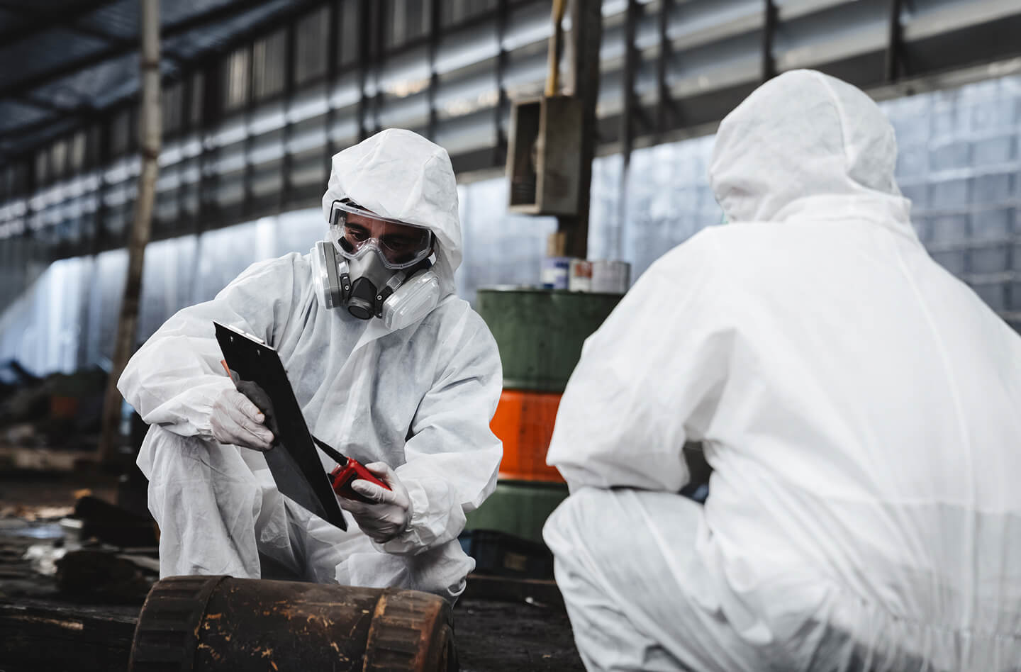 Workers in hazmat suits tracking waste