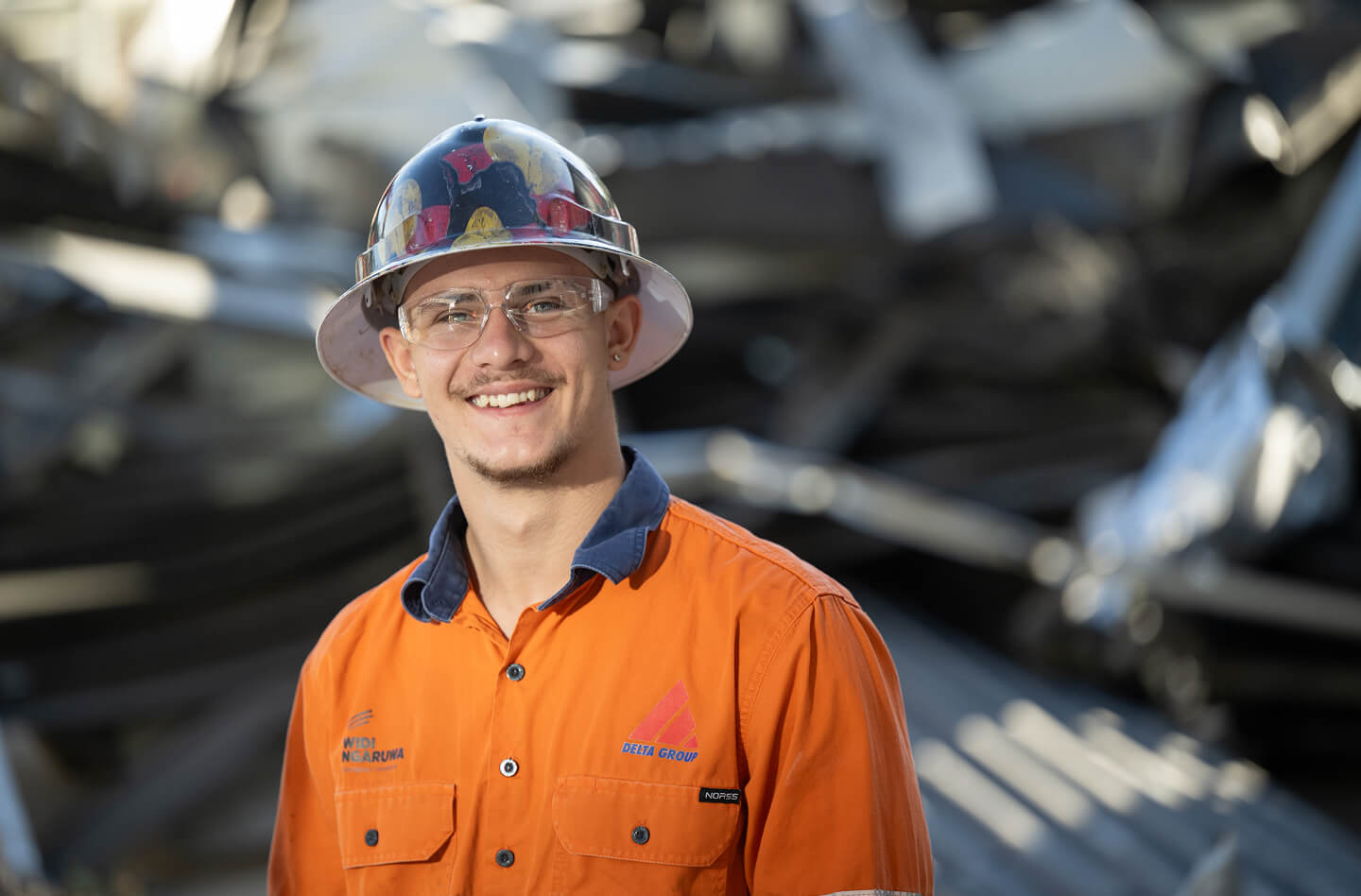 A man smiling to camera in tradewear